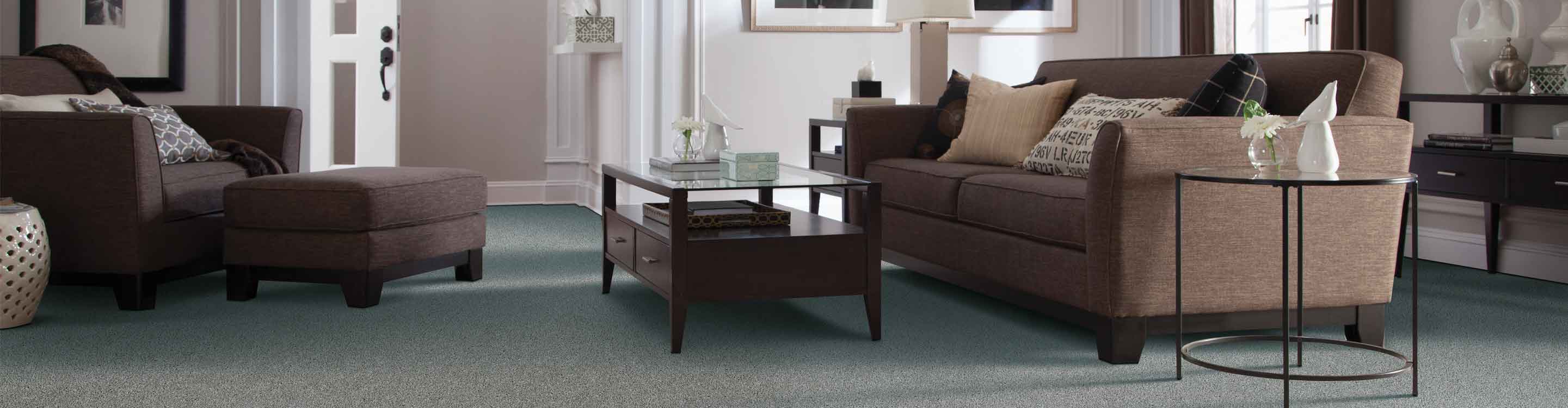 carpet in a living room with brown furniture
