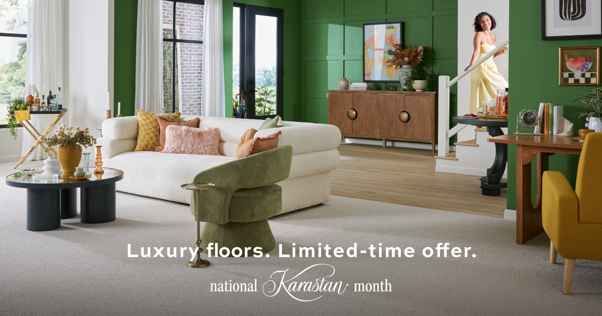 Woman sitting on a hardwood floor with a coffee mug in her hand.